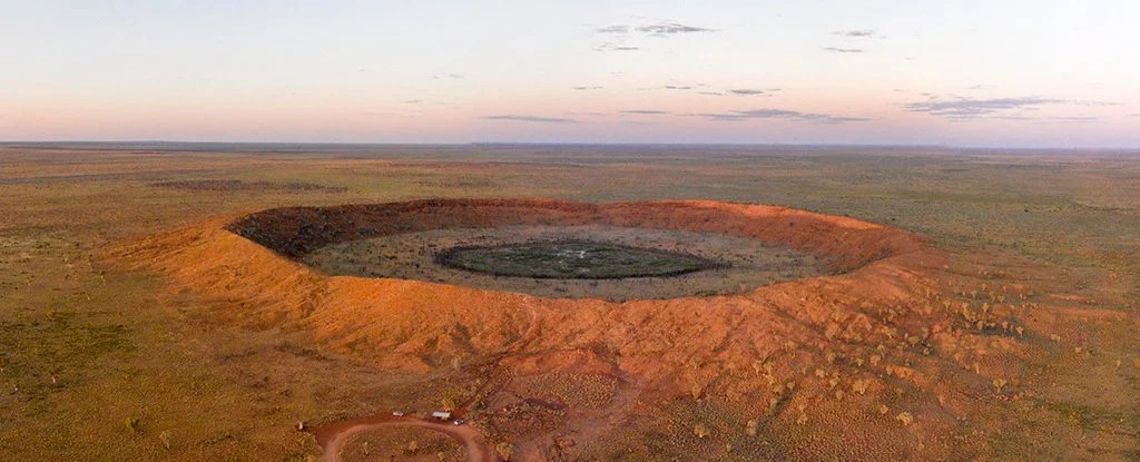 The Wolfe Creek meteorite crater in Western Australia. Wolfe Creek is about 875-m in diameter and 200' from the rim to the crater floor. Credit: Stephan Ridgway/Flickr/CC BY 2.0